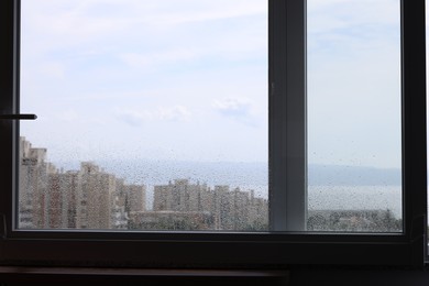 Photo of Window with water drops on rainy day