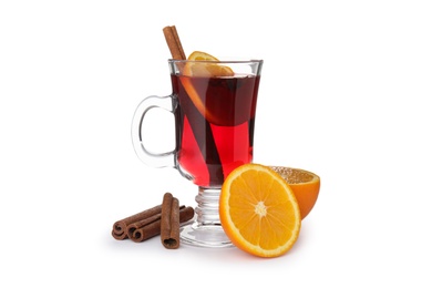 Photo of Glass cup of mulled wine, fresh orange and cinnamon sticks isolated on white