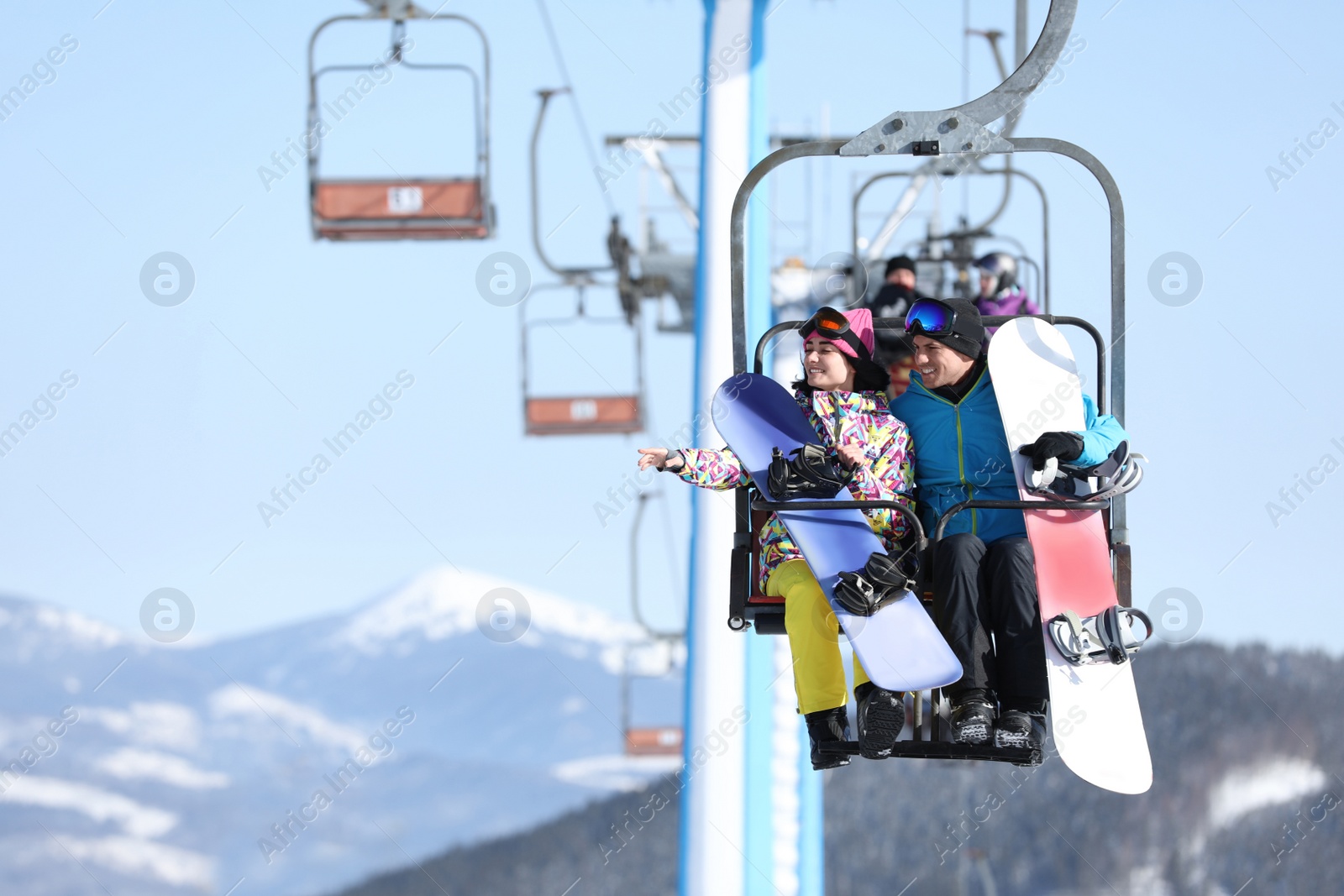 Photo of People using chairlift at mountain ski resort, space for text. Winter vacation