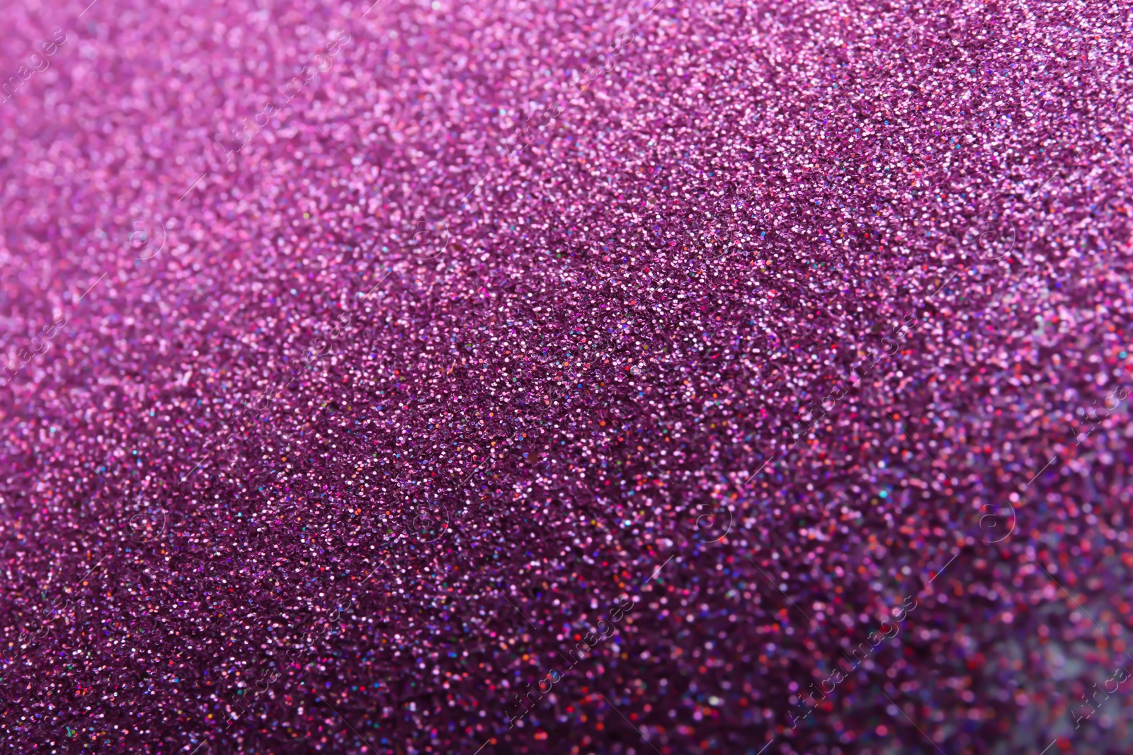 Photo of Closeup view of sparkling violet glitter background