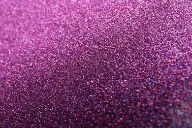 Photo of Closeup view of sparkling violet glitter background