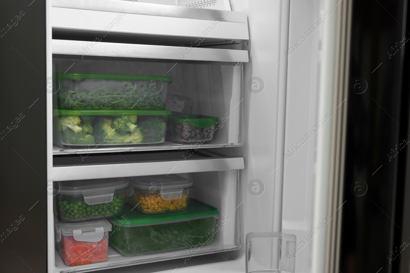 Photo of Plastic and glass containers with different fresh products in fridge. Food storage