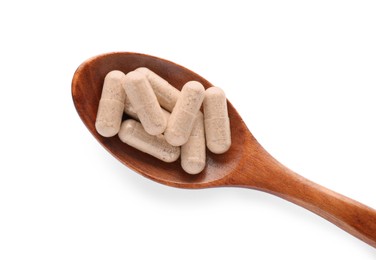 Photo of Gelatin capsules in spoon on white background, top view