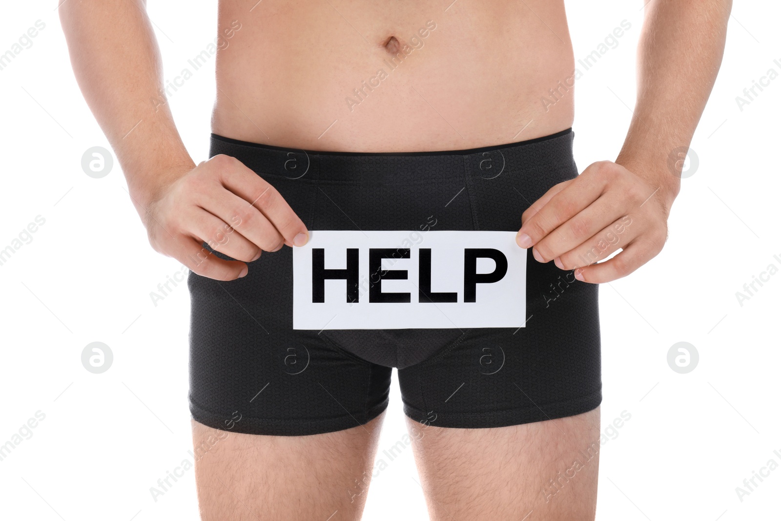 Photo of Man holding paper with word HELP on white background, closeup. Urology problems