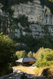 Photo of Picturesque view of small alley and house near cliff