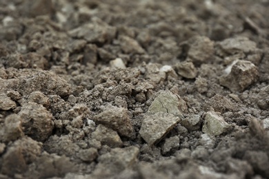 Photo of Textured ground surface as background, closeup. Fertile soil for farming and gardening