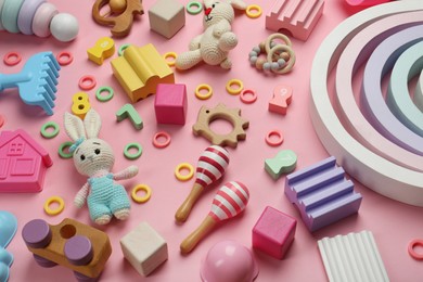 Many different children's toys on pink background