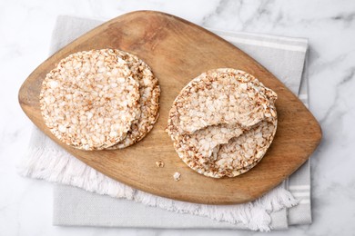 Photo of Crunchy buckwheat cakes on marble table, top view