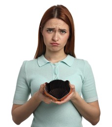 Upset woman with empty wallet on white background