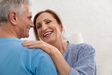 Photo of Happy senior couple dancing together at home, closeup
