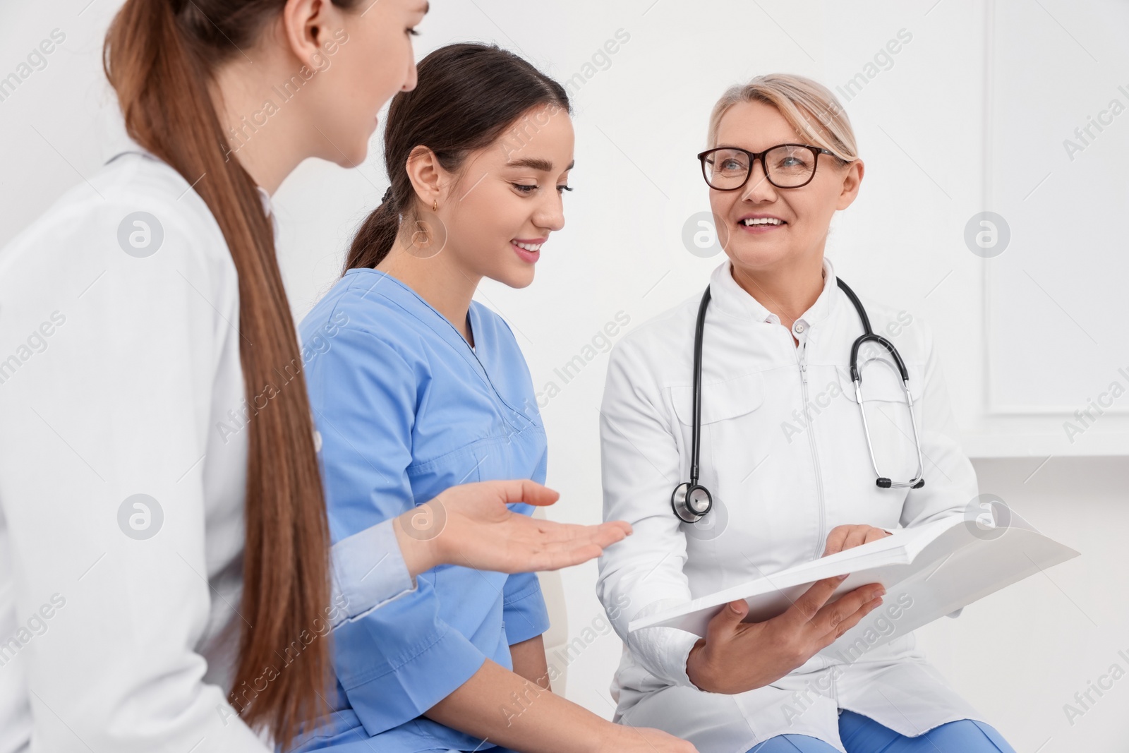 Photo of Team of professional doctors having discussion in clinic