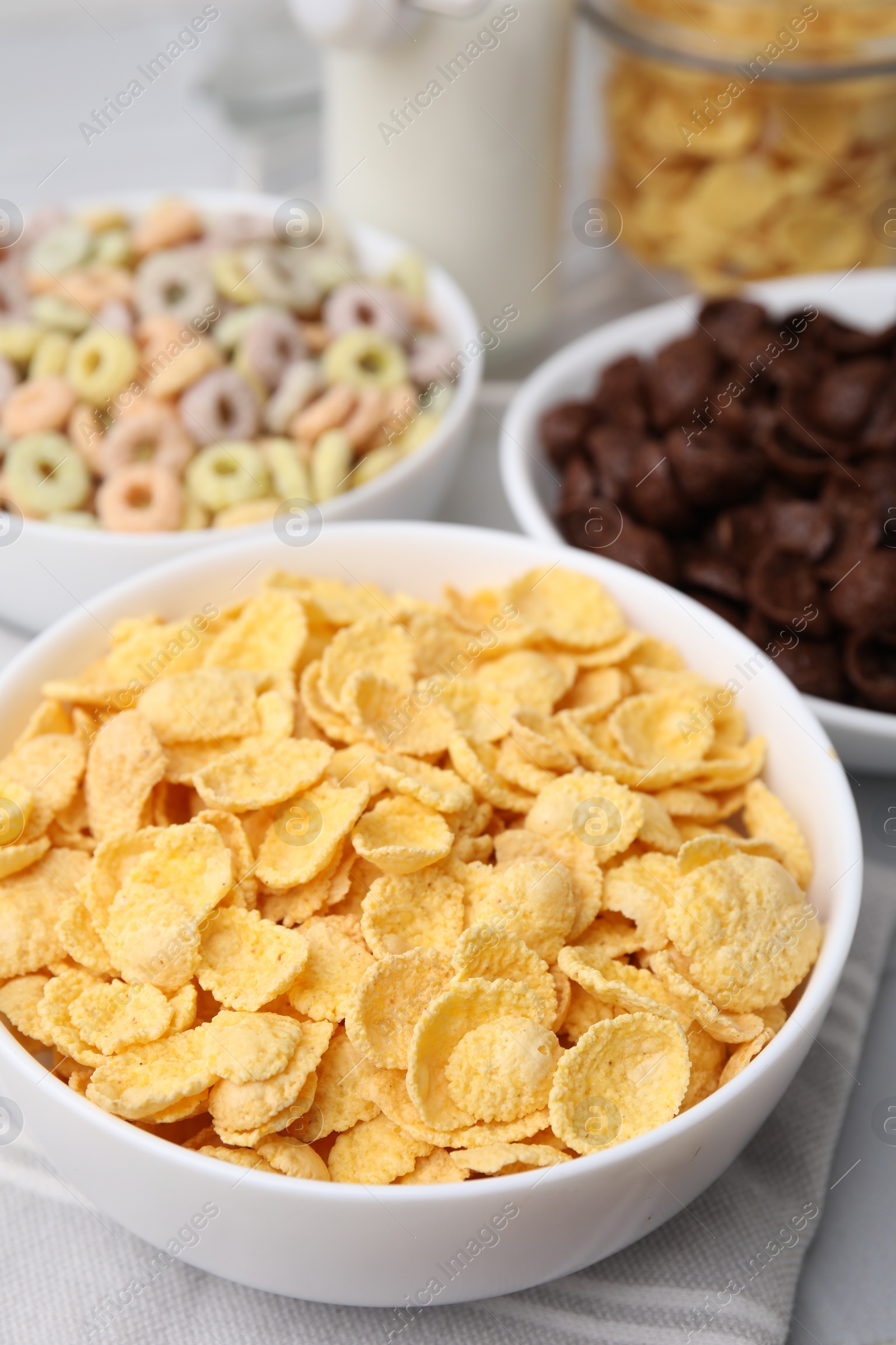 Photo of Different delicious breakfast cereals on table, closeup