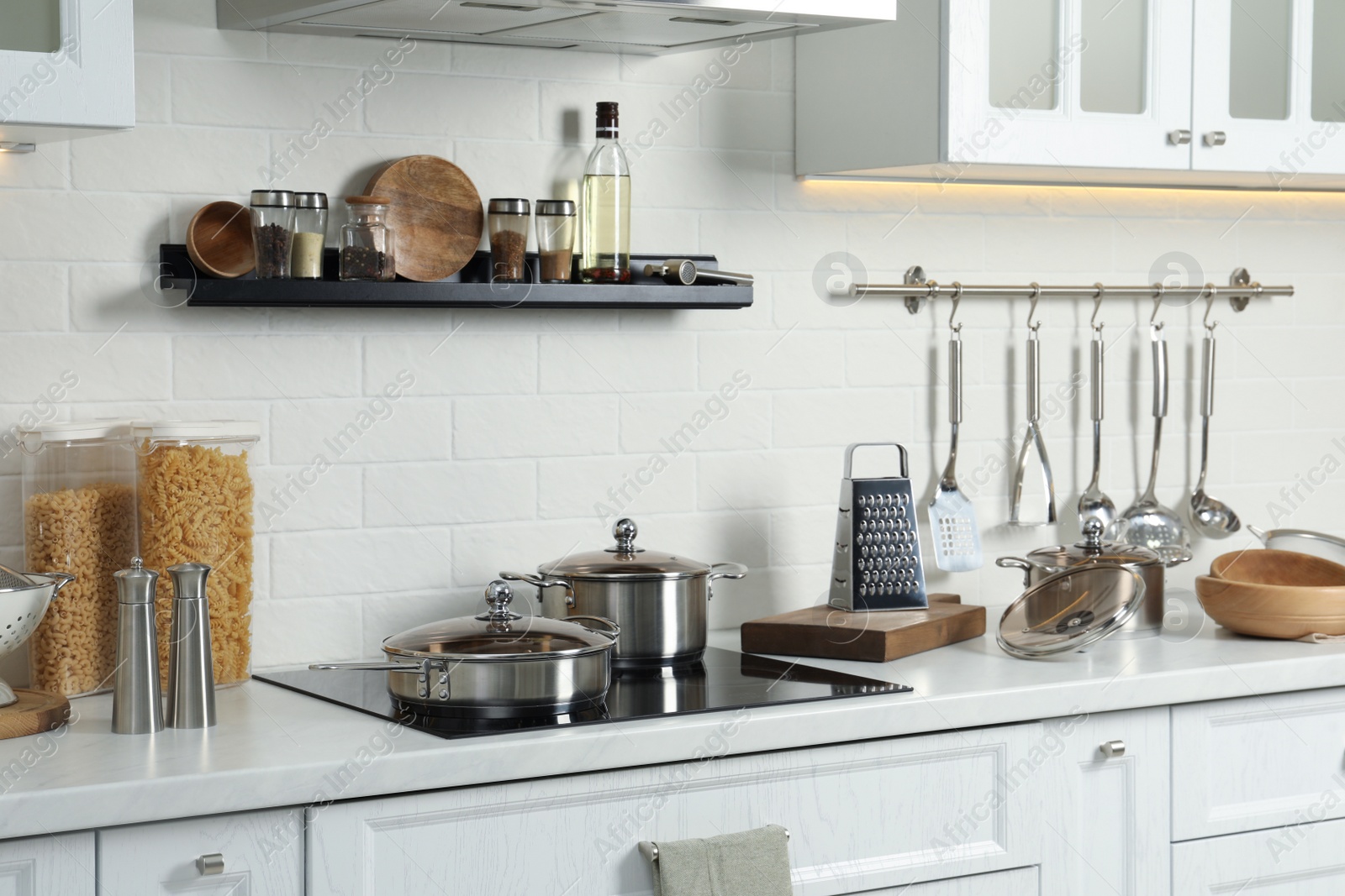 Photo of Countertop with different cooking utensils in kitchen