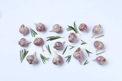 Photo of Fresh garlic and rosemary on white background, flat lay