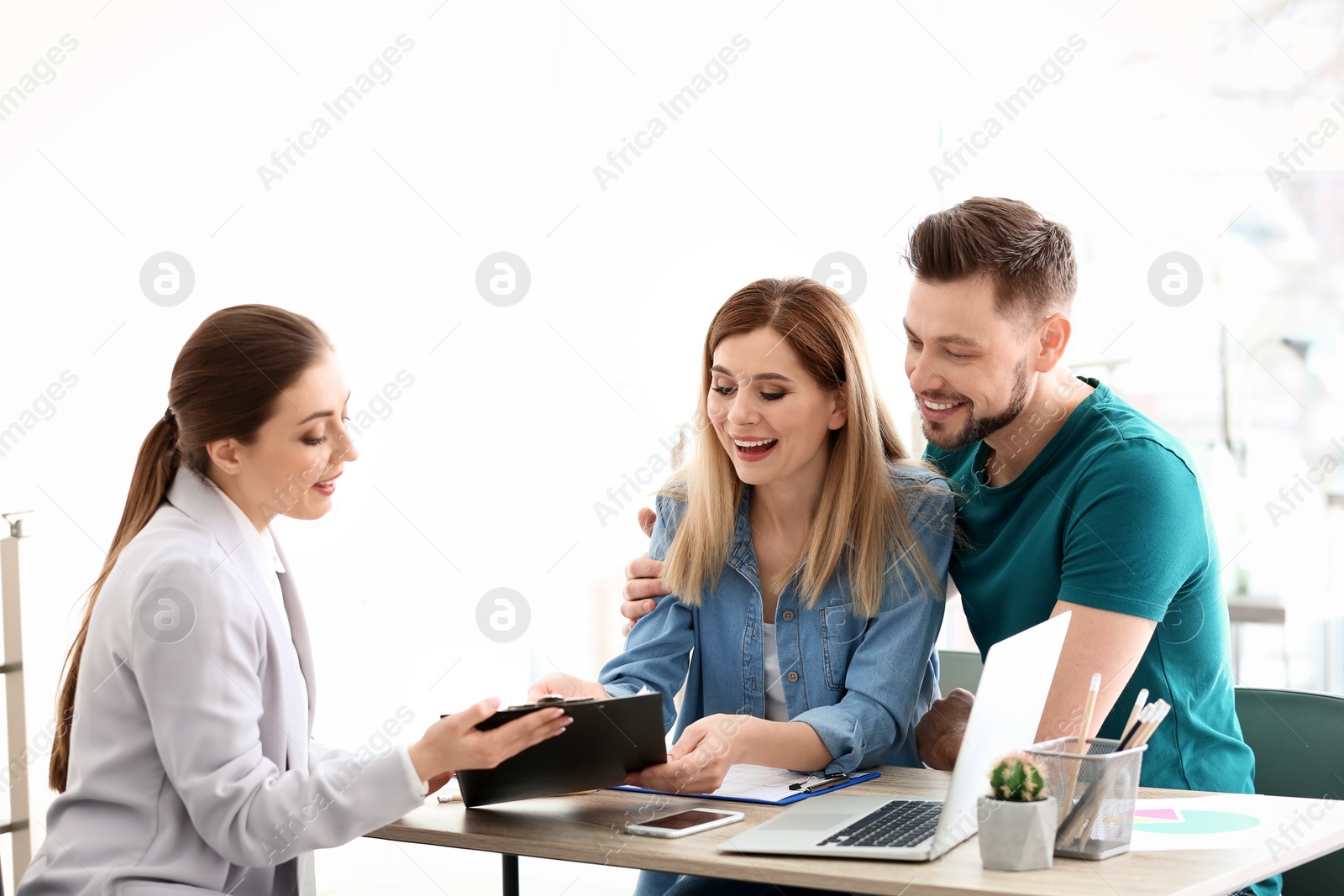 Photo of Young couple meeting with consultant in office