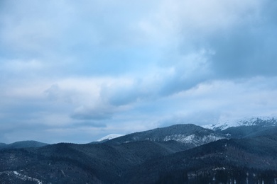 Photo of Beautiful mountain landscape with snowy hills and conifer forest in winter