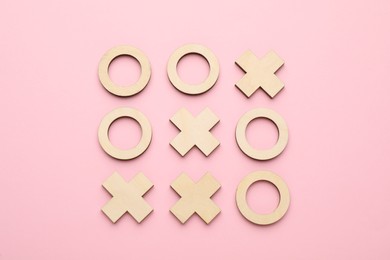 Tic tac toe set on bright pink background, flat lay