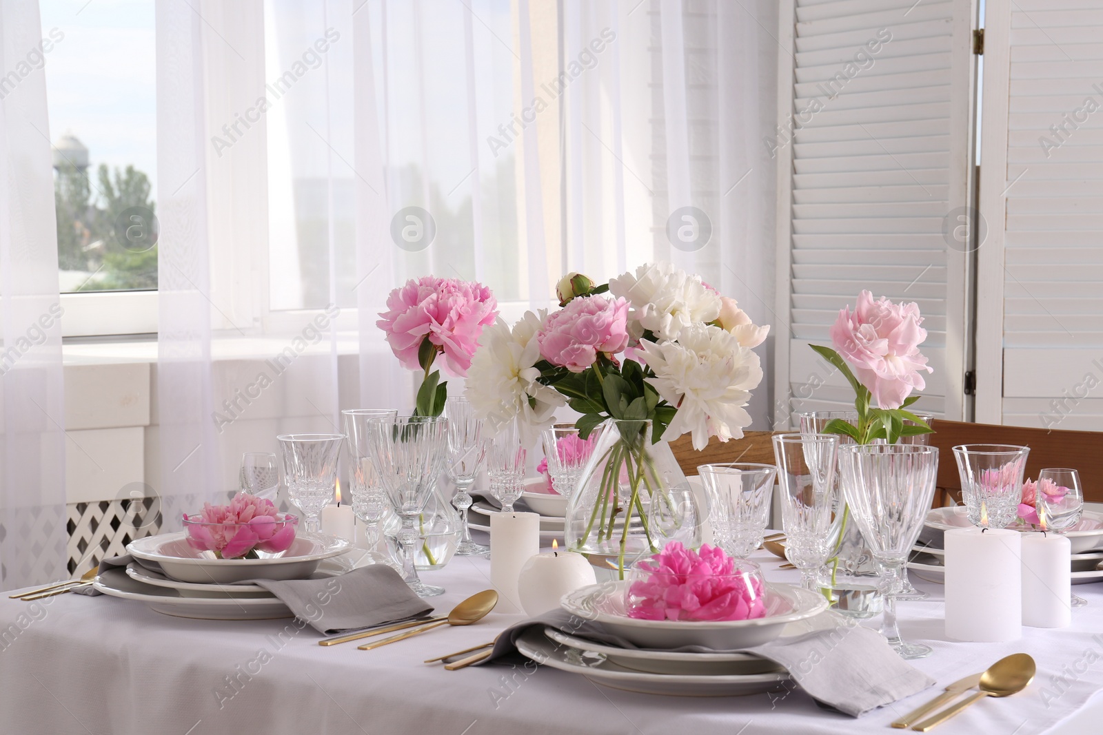 Photo of Stylish table setting with beautiful peonies in dining room