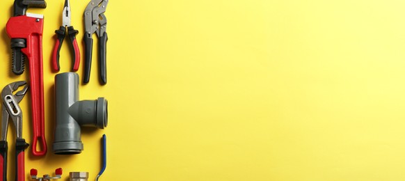 Image of Flat lay composition with plumber's tools on yellow background, space for text. Banner design