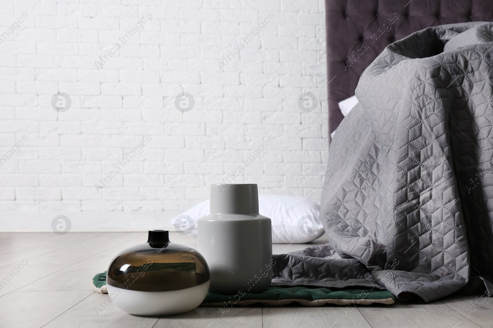 Photo of Bedroom room interior with vases on floor. Space for text