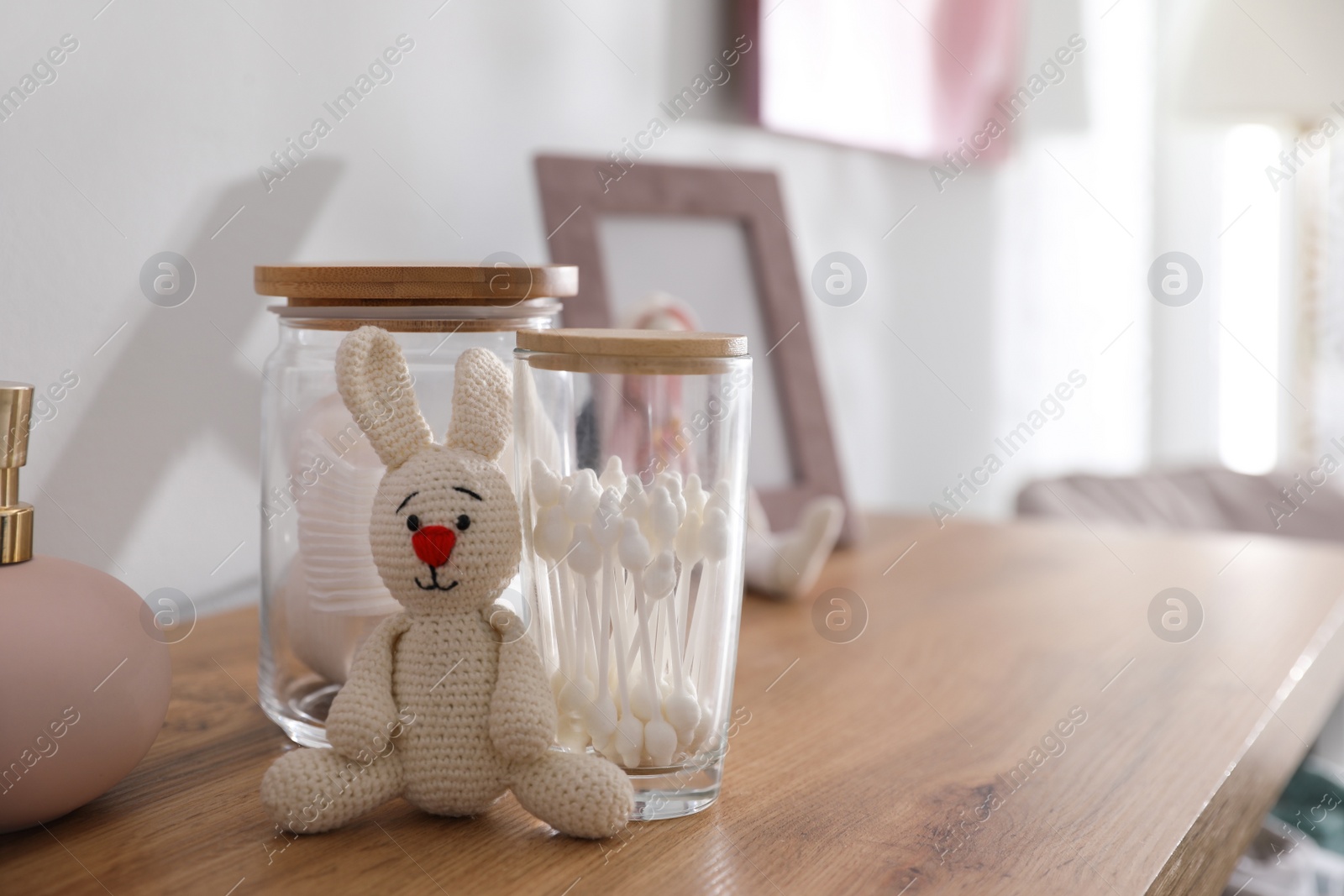 Photo of Baby accessories and toys on table in room