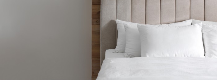 Image of Bed with soft pillows in room, space for text. Banner design