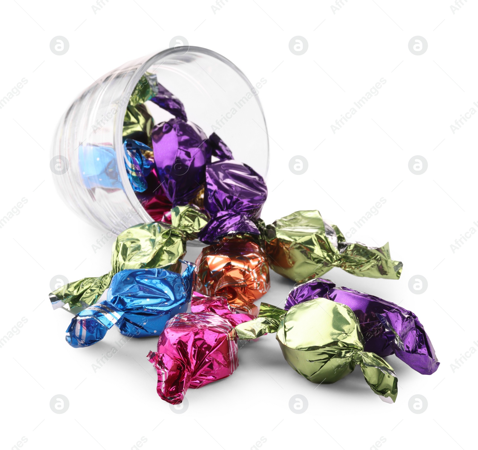 Photo of Glass cup with candies in colorful wrappers isolated on white