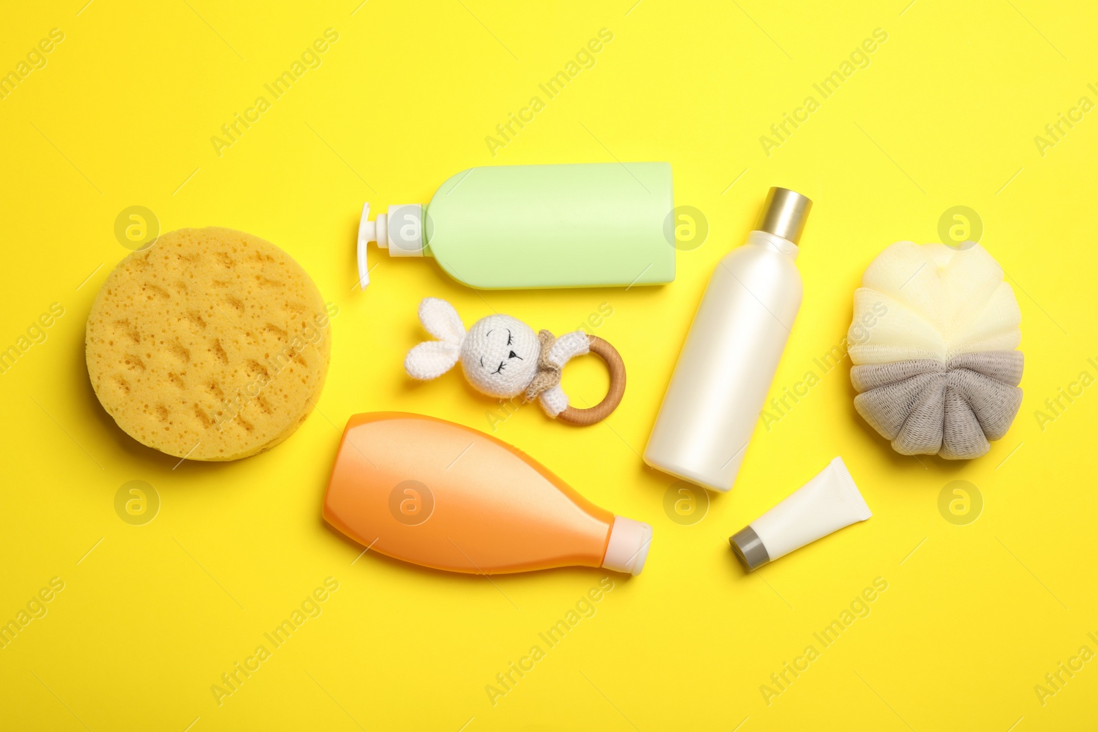 Photo of Flat lay composition with baby cosmetic products on yellow background