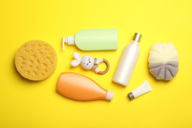 Flat lay composition with baby cosmetic products on yellow background