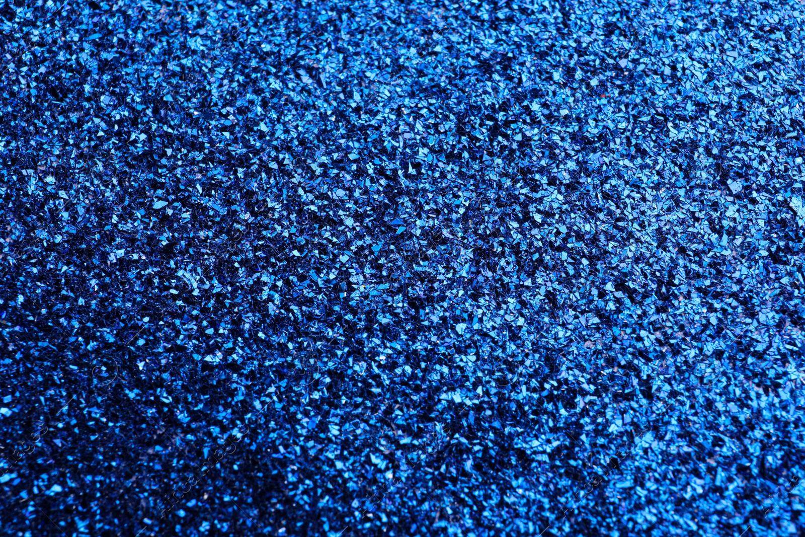 Photo of Beautiful shiny blue glitter as background, closeup