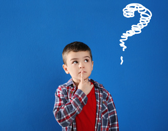 Image of Emotional boy with drawing of question mark on blue background