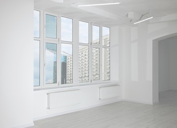 New empty room with clean windows and white wall