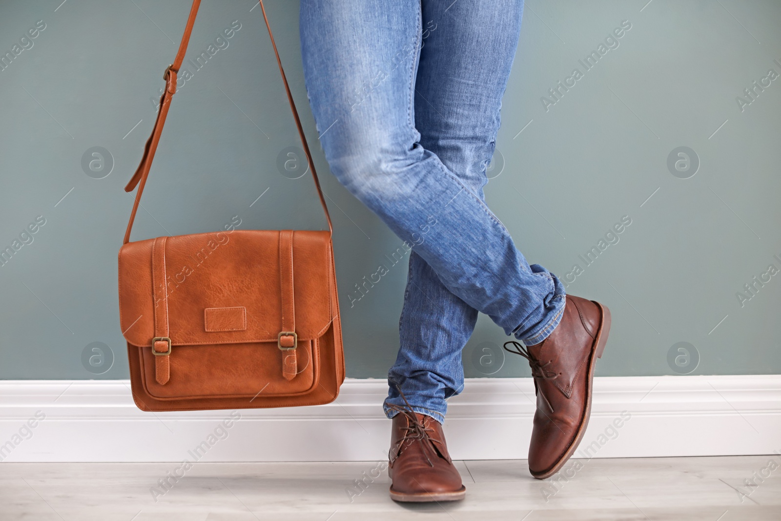 Photo of Man in leather shoes with stylish bag indoors