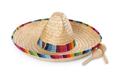 Photo of Mexican sombrero hat and maracas isolated on white