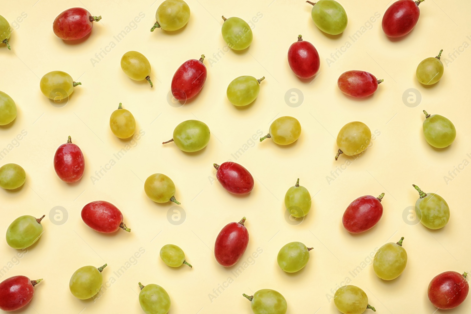 Photo of Fresh ripe juicy grapes on color background, top view