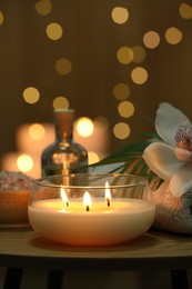 Beautiful spa composition with burning candle on wooden table, closeup