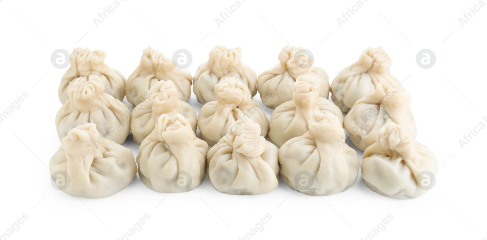 Photo of Many tasty khinkali (dumplings) isolated on white. Georgian cuisine