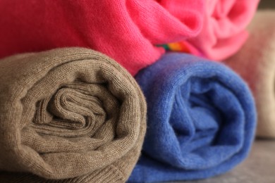 Closeup view of many rolled color sweaters