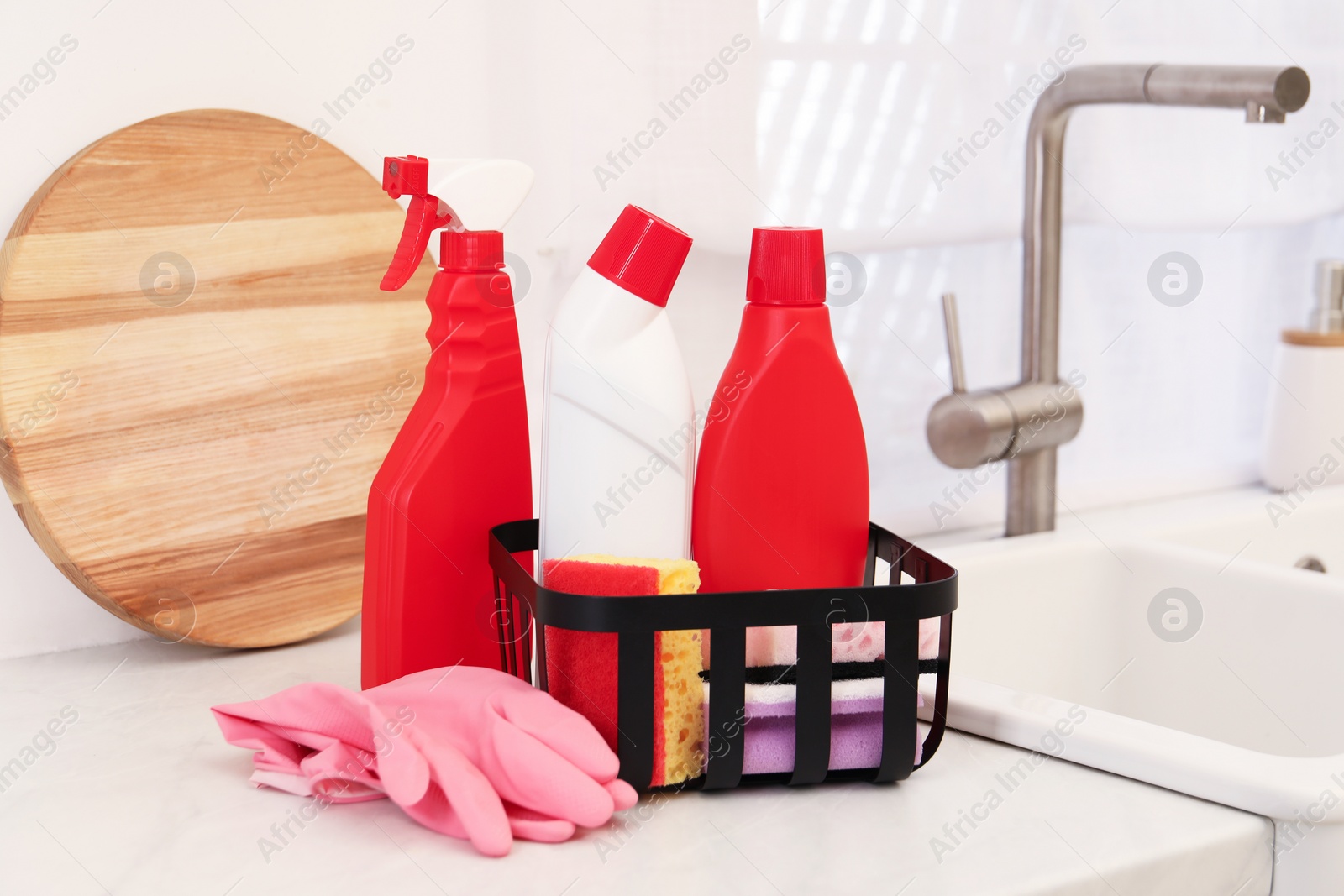Photo of Different cleaning supplies on counter in kitchen