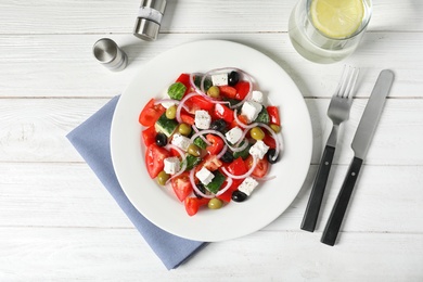 Photo of Plate with delicious salad on table, top view