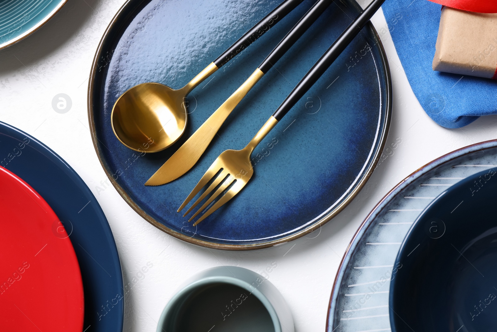 Photo of Set of dishware and cutlery on white background, flat lay