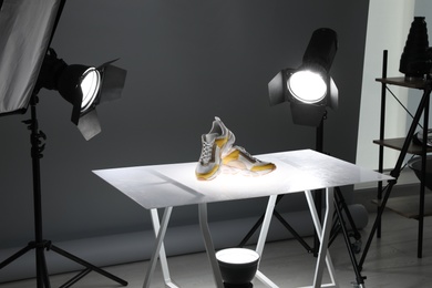 Photo of Professional photography equipment prepared for shooting stylish shoes in studio