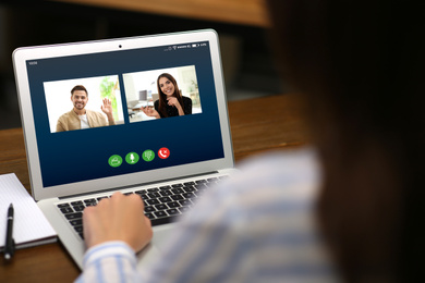 Woman having online meeting with her team via laptop, closeup