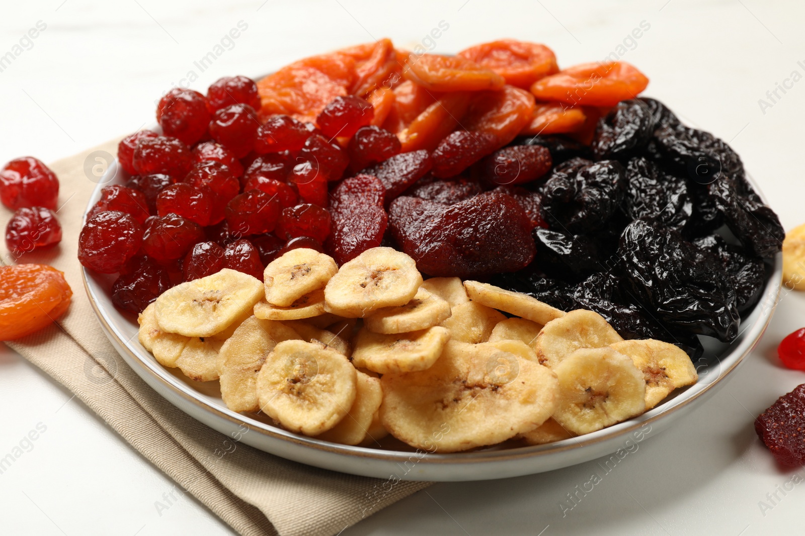 Photo of Delicious dried fruits on white table, closeup