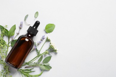 Photo of Bottle of essential oil, different herbs and flowers on white background, flat lay. Space for text