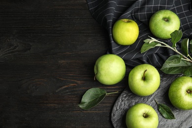 Photo of Flat lay composition of fresh ripe green apples on black wooden table, space for text