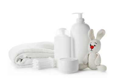 Photo of Baby cosmetic products, toy and cotton swabs on white background