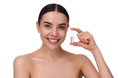 Beautiful young woman holding skincare ampoule on white background