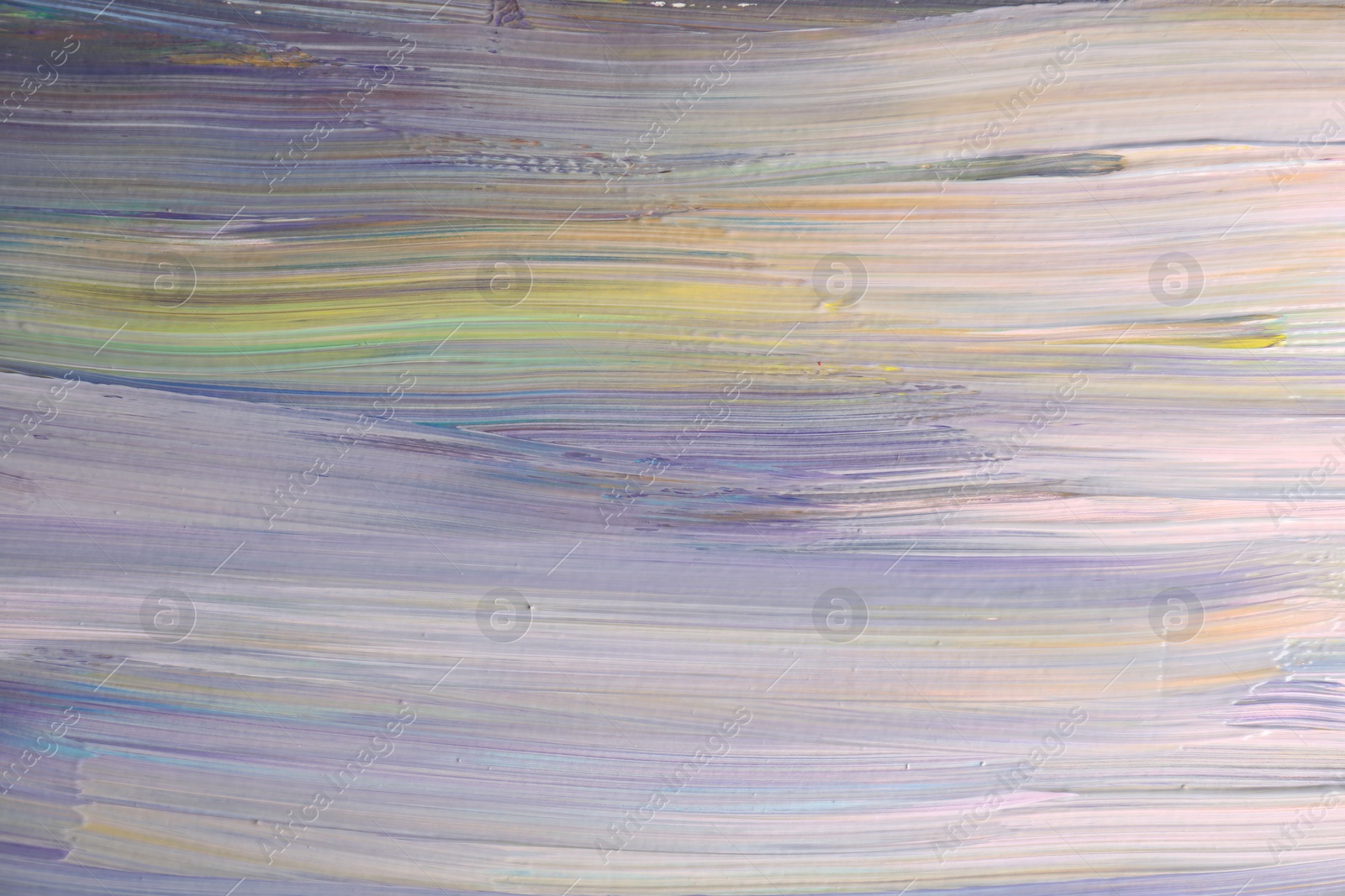 Photo of Strokes of colorful paints on canvas, closeup