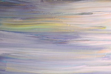 Photo of Strokes of colorful paints on canvas, closeup